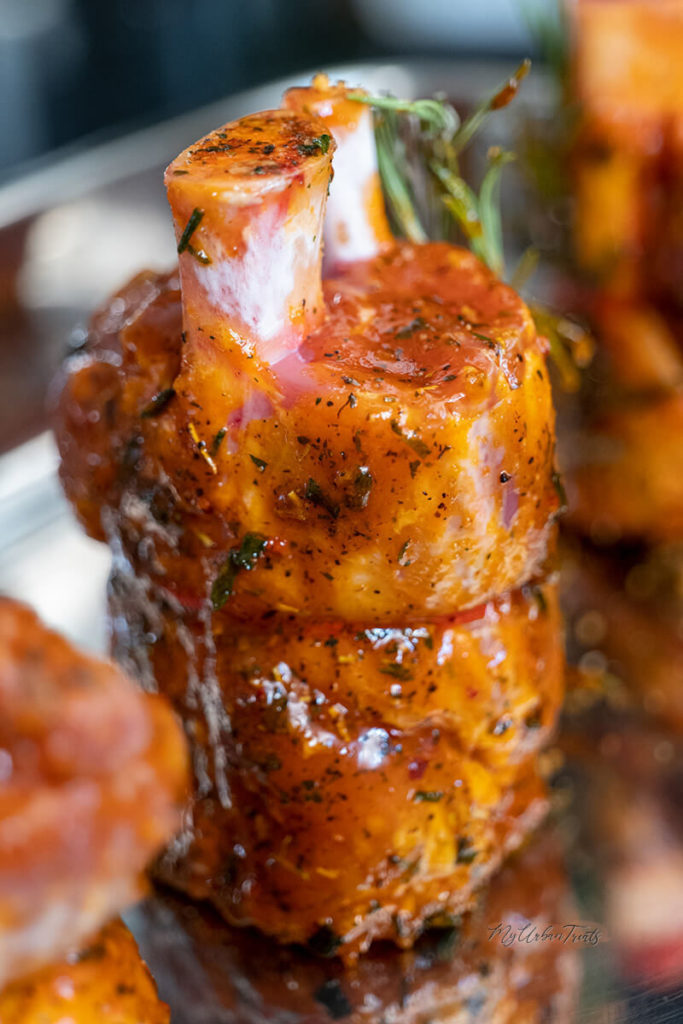 A basted and marinated pork shank in barbeque sauce and rosemary 