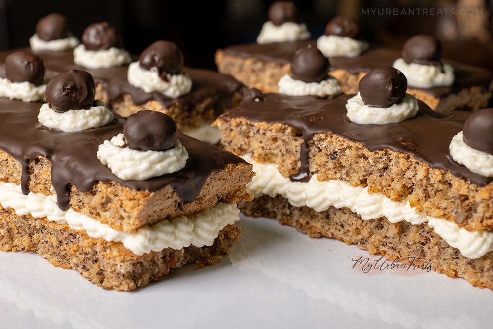 Hazelnut cake recipe filled with vanilla heavy cream and topped with chocolate ganache 