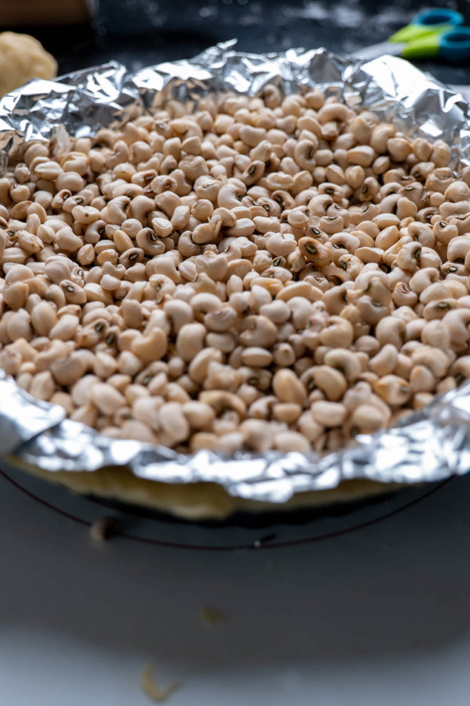 Blind baking pie crust with beans and aluminium foil