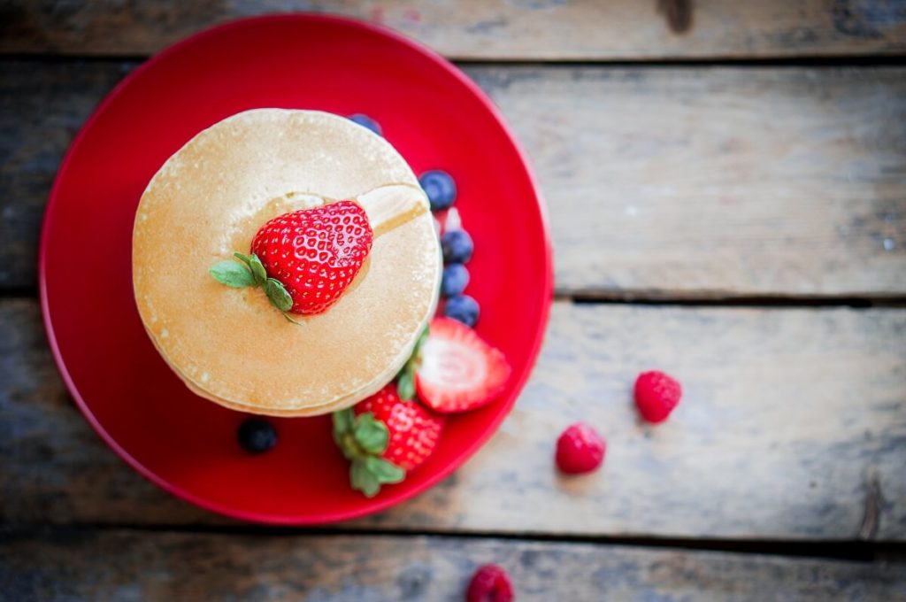 healthy tasty pancakes with berries and honey