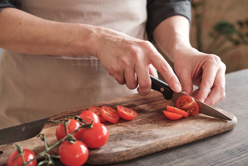 Paring knife used to slice small tomatoes.